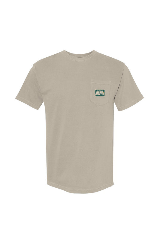 Beige t-shirt with a small green logo on a white background