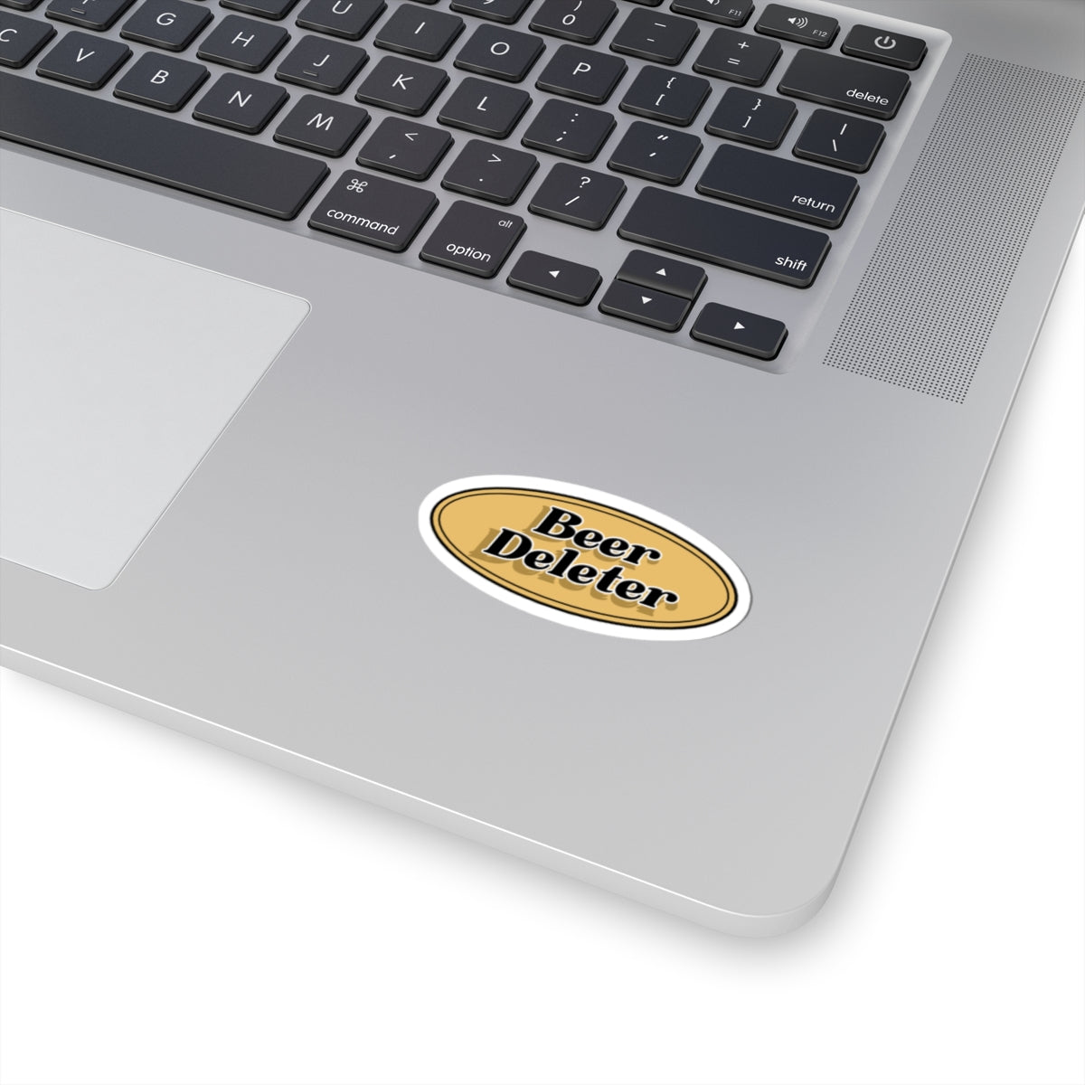Laptop with a 'Beer Deleter' sticker on the palm rest area
