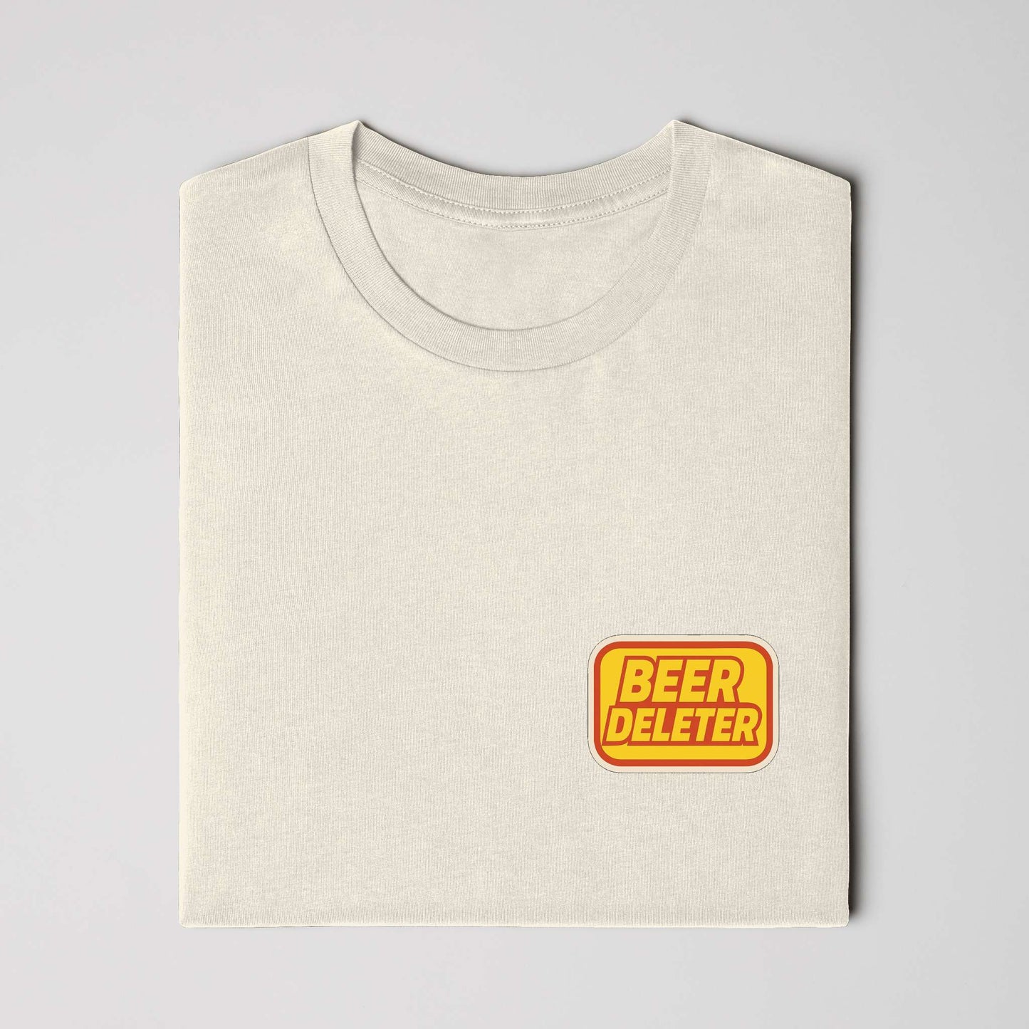 Folded Beige t-shirt with yellow and red 'Beer Deleter' logo on a white background