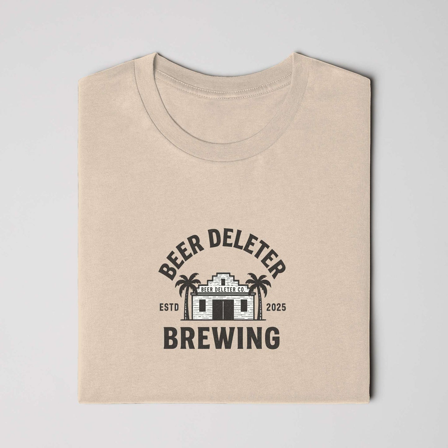 Beige t-shirt folded with 'Beer Deleter Brewing' logo on a white background