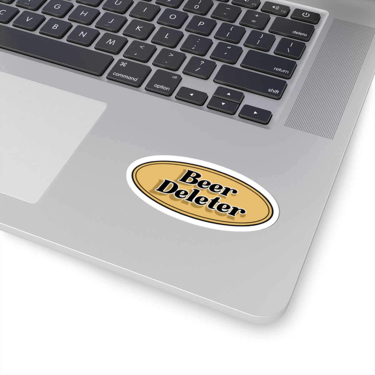 Laptop with a 'Beer Deleter' sticker on the palm rest area